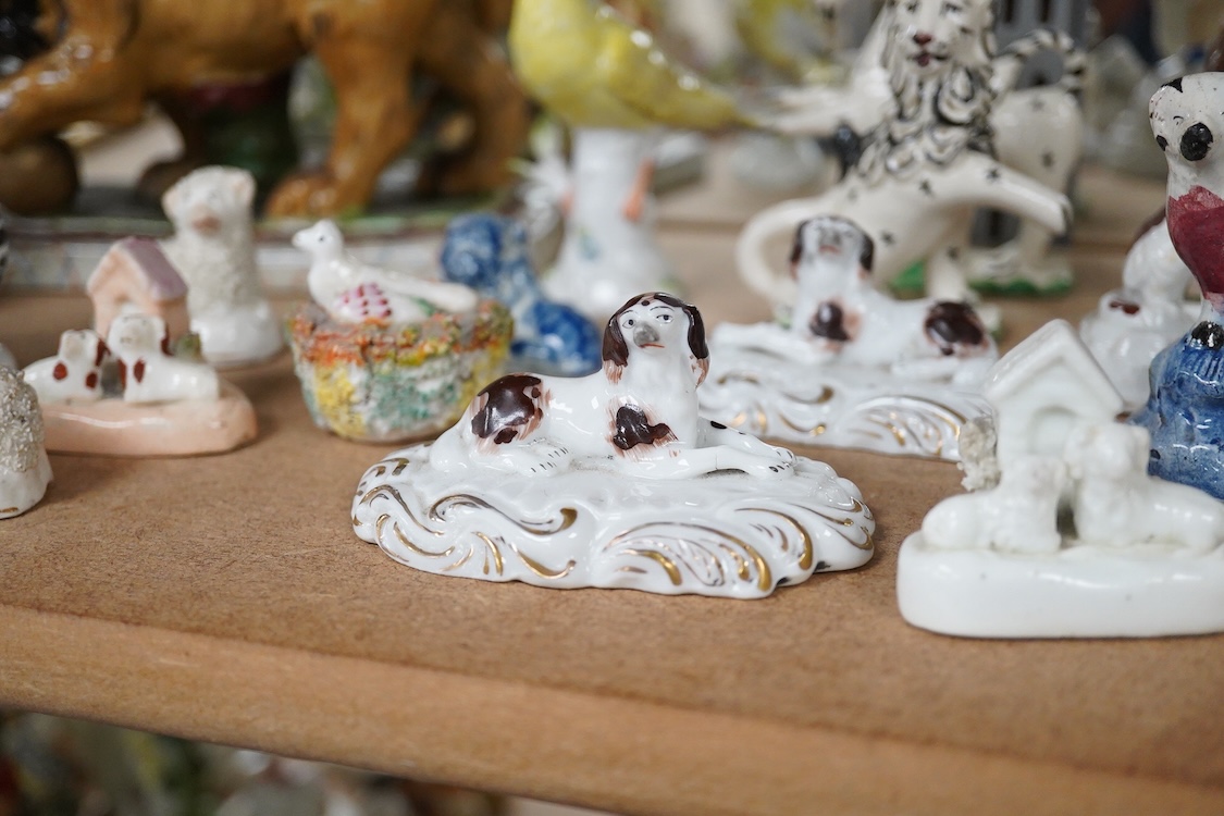 A collection of 19th/20th century Staffordshire and continental porcelain models of animals and birds, including a 20th century Meissen figure of a canary, two Continental porcelain Panthers, two similar recumbent dogs,